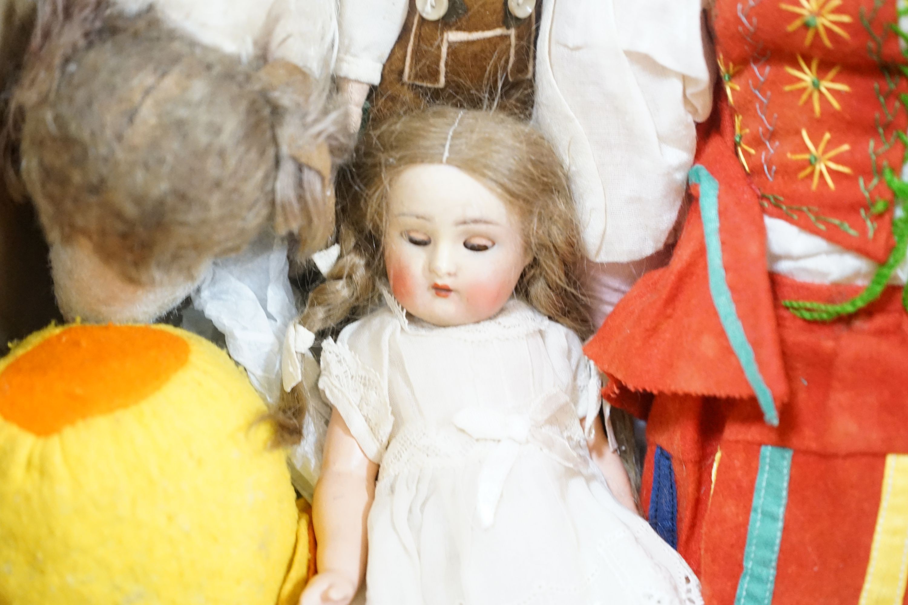 A collection of dolls and two soft toys